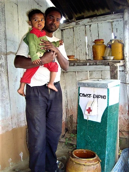 Family in Jhapa, Nepal using a concrete biosand filter to treat drinking water. Source: ENPHO (n.y).